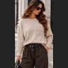 Stylowy sweter w odcieniach beżu z ozdobną kieszenią